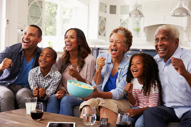 multi-generation-black-family-watching-sport-tv-home-71525264